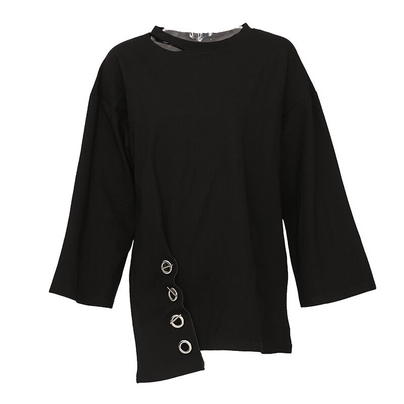 Women's black long sleeve asymmetric top with metal accents for a stylish, casual look.