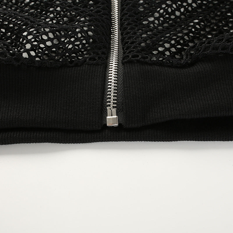 Close-up of a black mesh crop top featuring a zipper detail, perfect for gothic and streetwear styles.