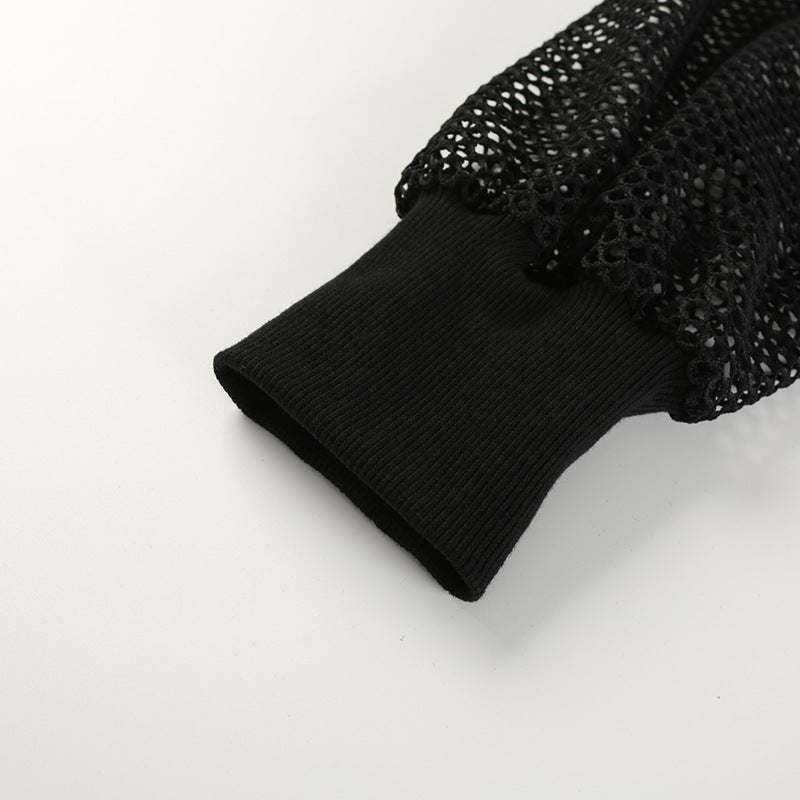 Close-up of black mesh sleeve with ribbed cuff for women's gothic crop top, showcasing sexy streetwear style.