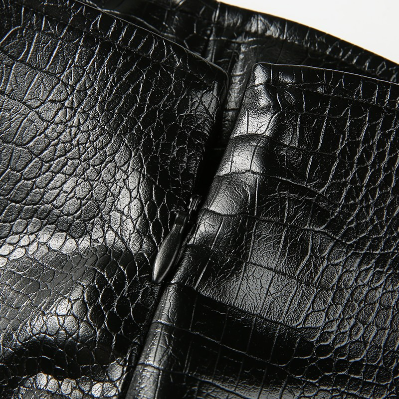 Close-up of black PU leather texture on a mini skirt showcasing style and quality.