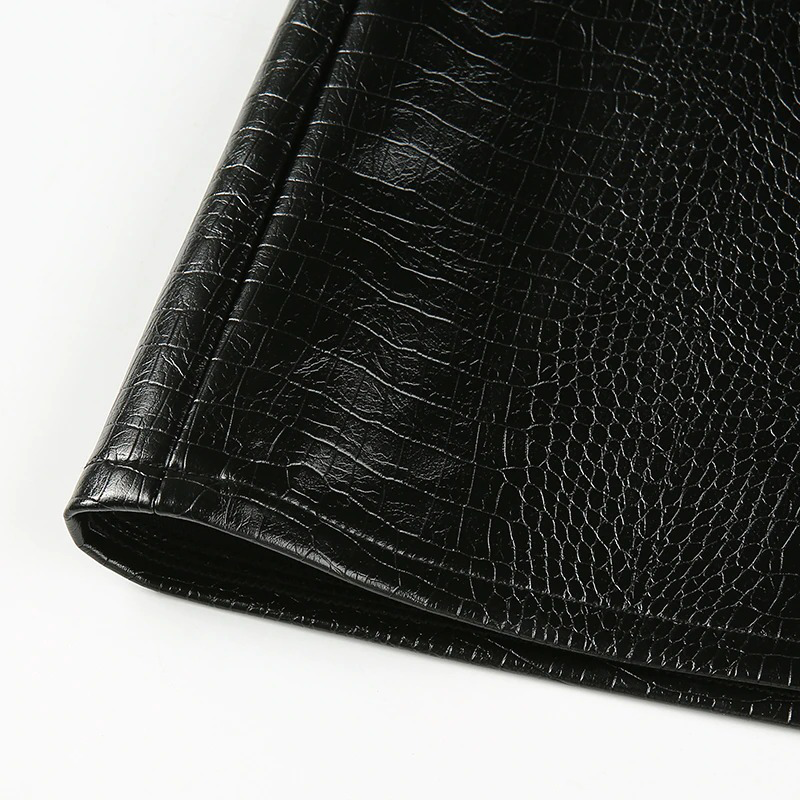 Close-up of black PU leather texture for a women's sexy mini skirt, showcasing its stylish details.