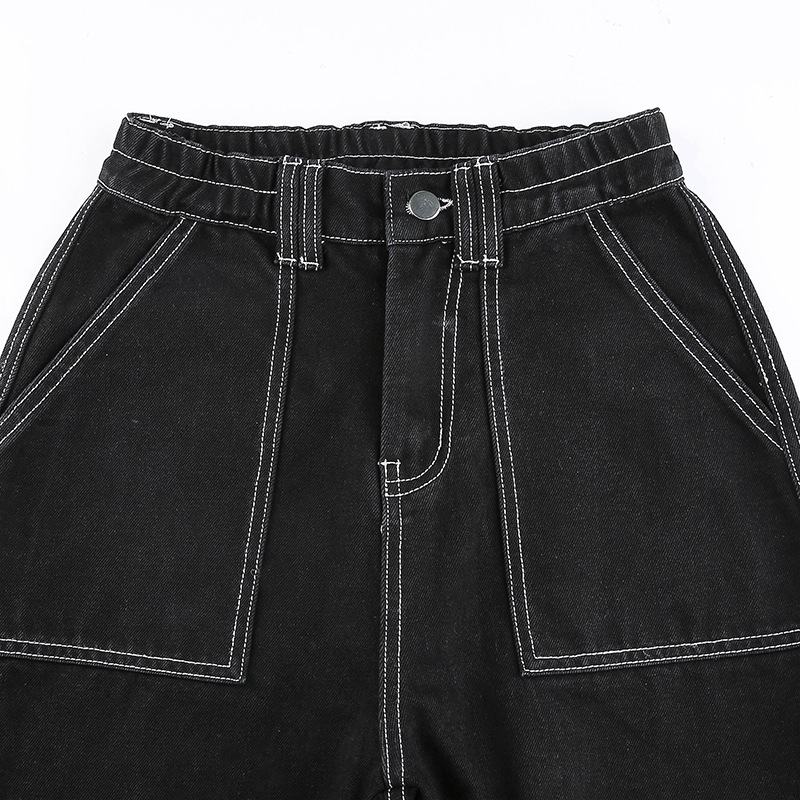 Close-up of women's black high-waist pants showcasing unique pockets and stitching details for stylish streetwear.