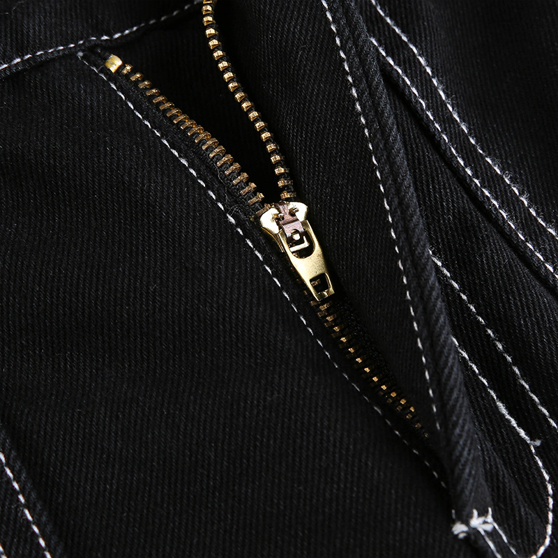 Close-up of a zipper detail on women's black high-waist pants, showcasing stylish cotton streetwear.
