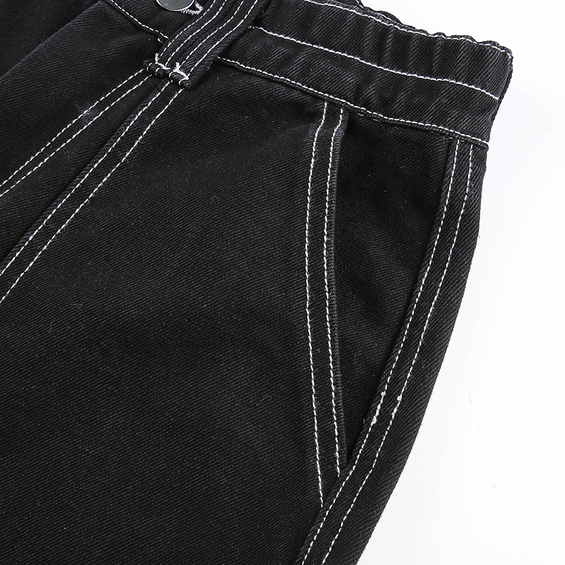 Close-up of women's black high-waist pants showing stylish stitching and pockets, perfect for alternative streetwear fashion.