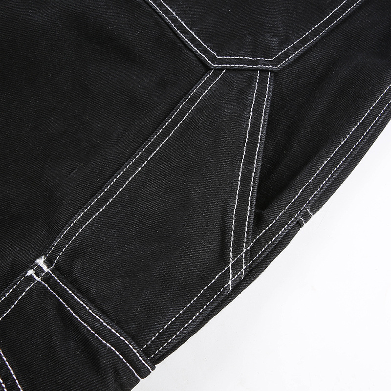 Close-up of black cotton streetwear women’s pants showcasing high-waist design and contrasting white stitching details.
