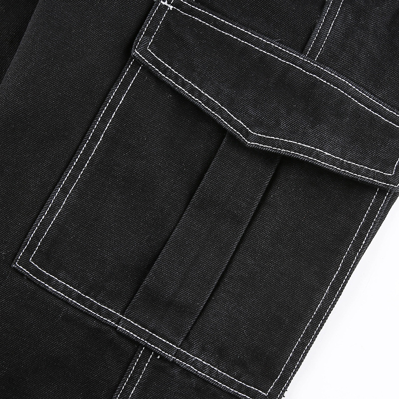 Close-up of women's black cotton pants, featuring a stylish pocket design and contrasting white stitching.
