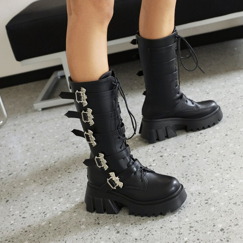 Stylish women's black platform thigh boots with bat buckles and lace-up design, perfect for punk fashion enthusiasts.