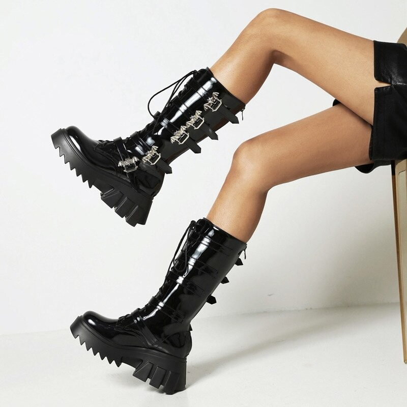 Stylish women's black platform thigh warm boots with bat buckles, perfect for a punk fashion statement.