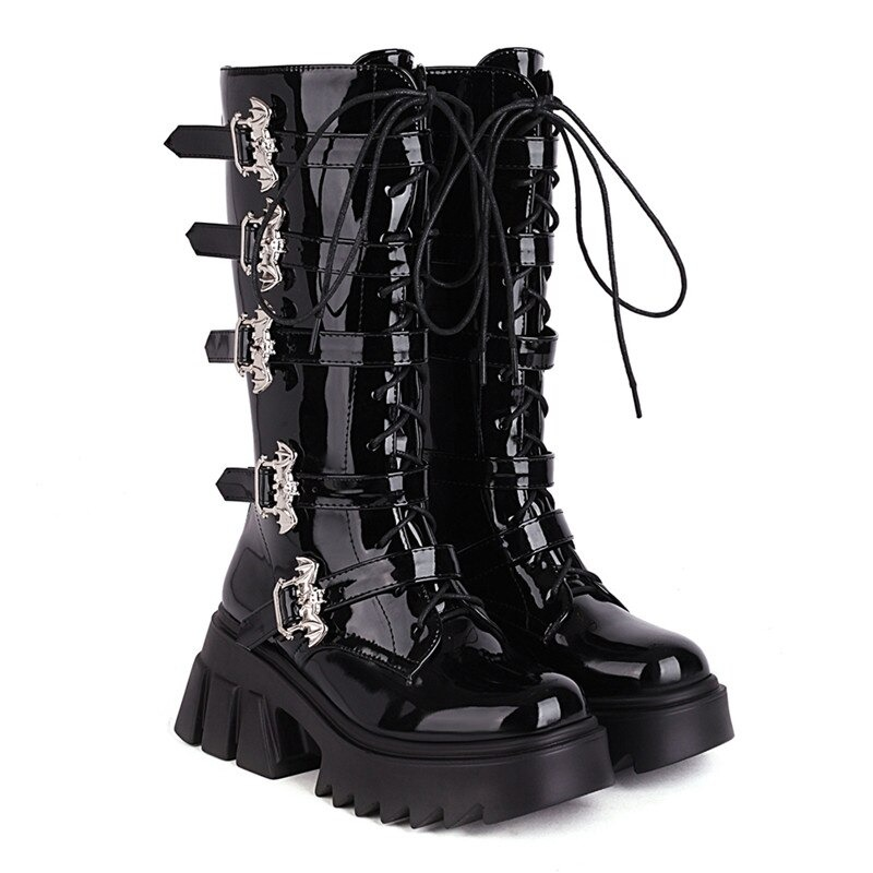 Stylish women's black platform thigh warm boots with bat buckles, made from glossy patent leather.