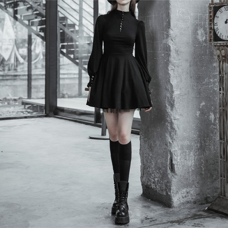 Women's gothic black dress with lantern sleeves, buttons, and flared skirt, stylishly paired with knee-high socks.