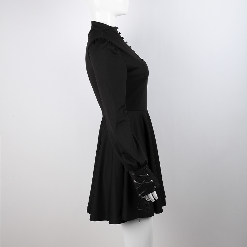 Women's Gothic black pleated dress with long sleeves and decorative ties, showcasing elegant style and a flared skirt.