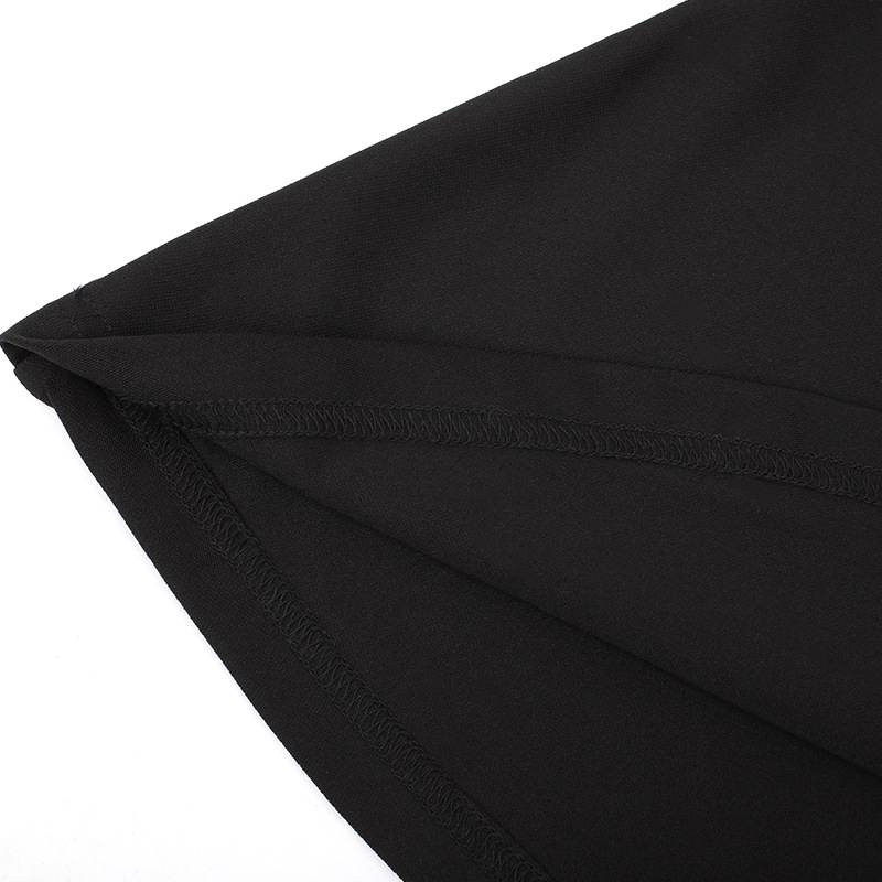 Close-up of the hem and seam detail of a black gothic-style dress, showcasing quality fabric and craftsmanship.