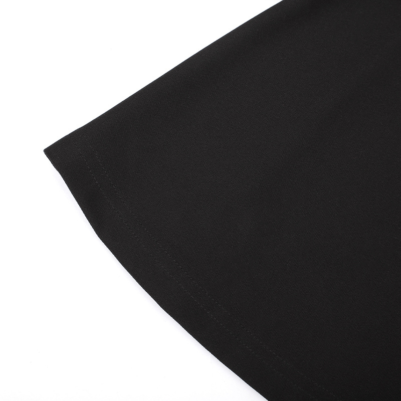 Close-up of the hem of a women's black gothic style dress showcasing its smooth fabric and elegant finish.