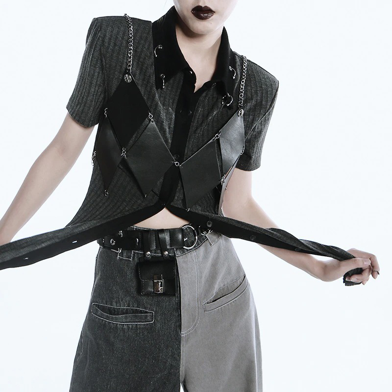 Stylish black and gray edgy outfit featuring a sleeveless top with chains and a unique design.