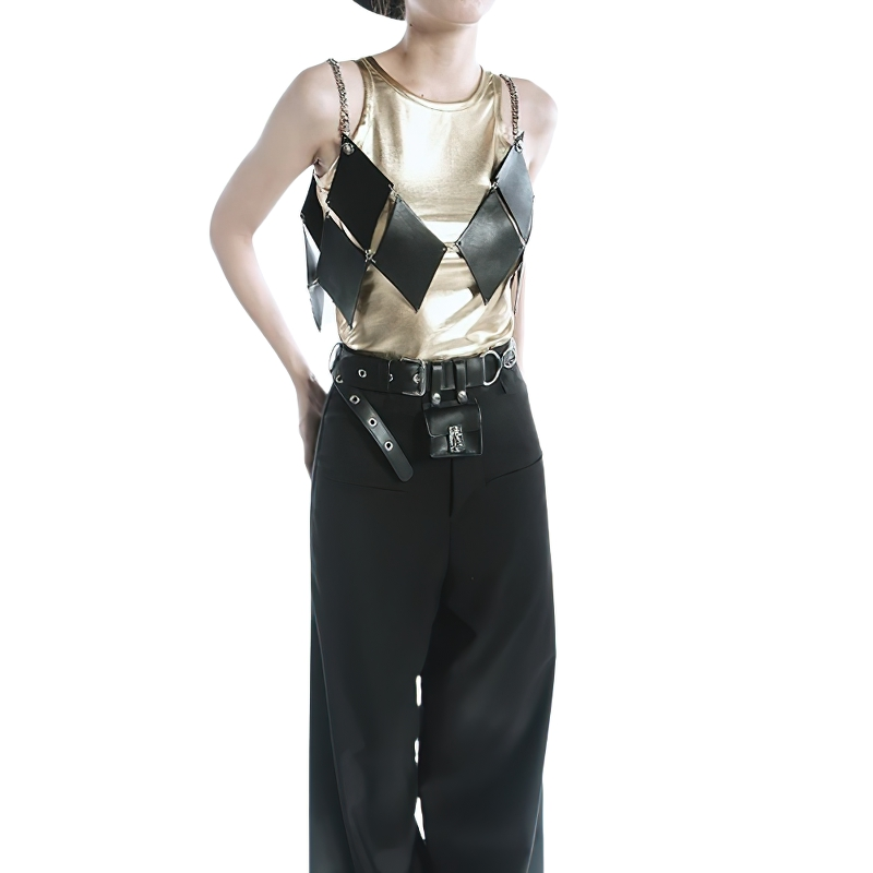 Trendy gold and black sleeveless top with geometric design, paired with black pants, showcasing alternative fashion style.