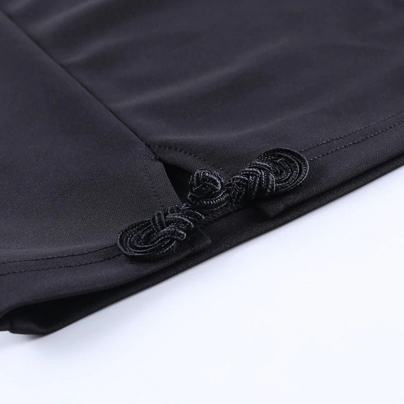 Close-up of black fabric with decorative knot detail, showcasing the elegant design of women's gothic mini dress.