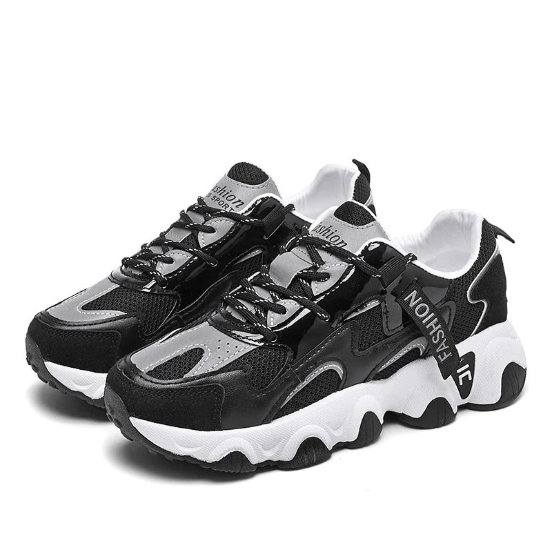 Women's chunky sneakers in black and white, featuring breathable mesh and stylish laces for trendy casual wear.