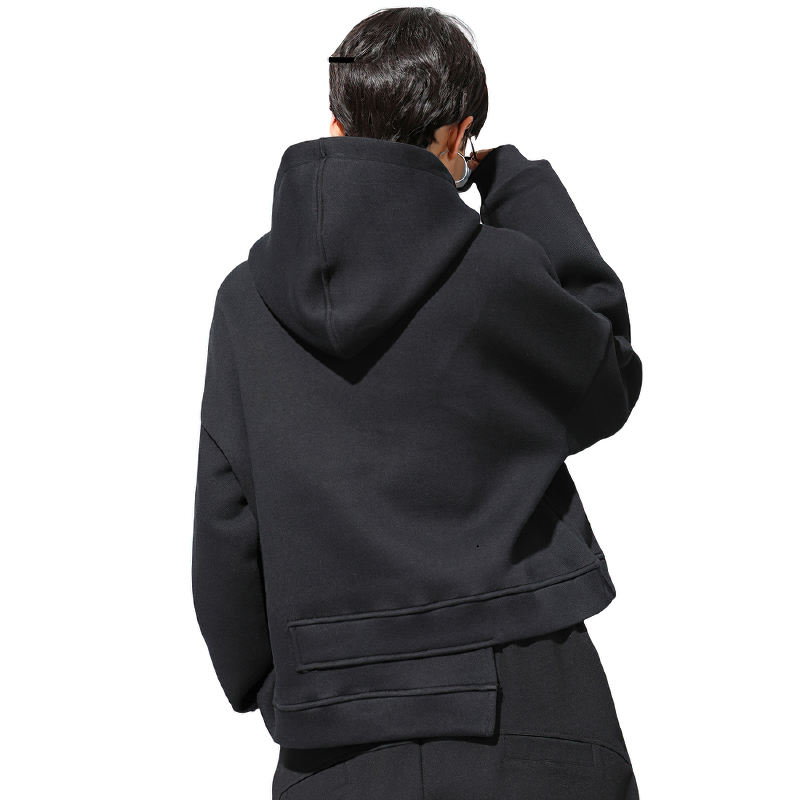 Back view of a women's oversized black drawstring sweatshirt with a hood, showcasing its stylish and relaxed design.