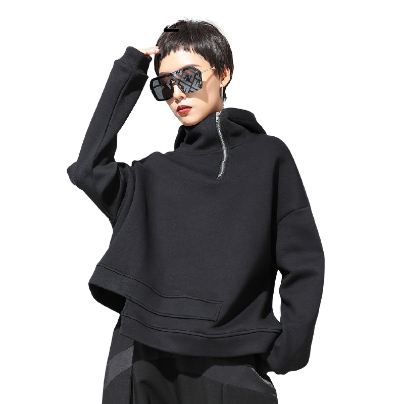 Stylish woman in a black double layer oversized sweatshirt with a hood and sunglasses, showcasing casual comfort.
