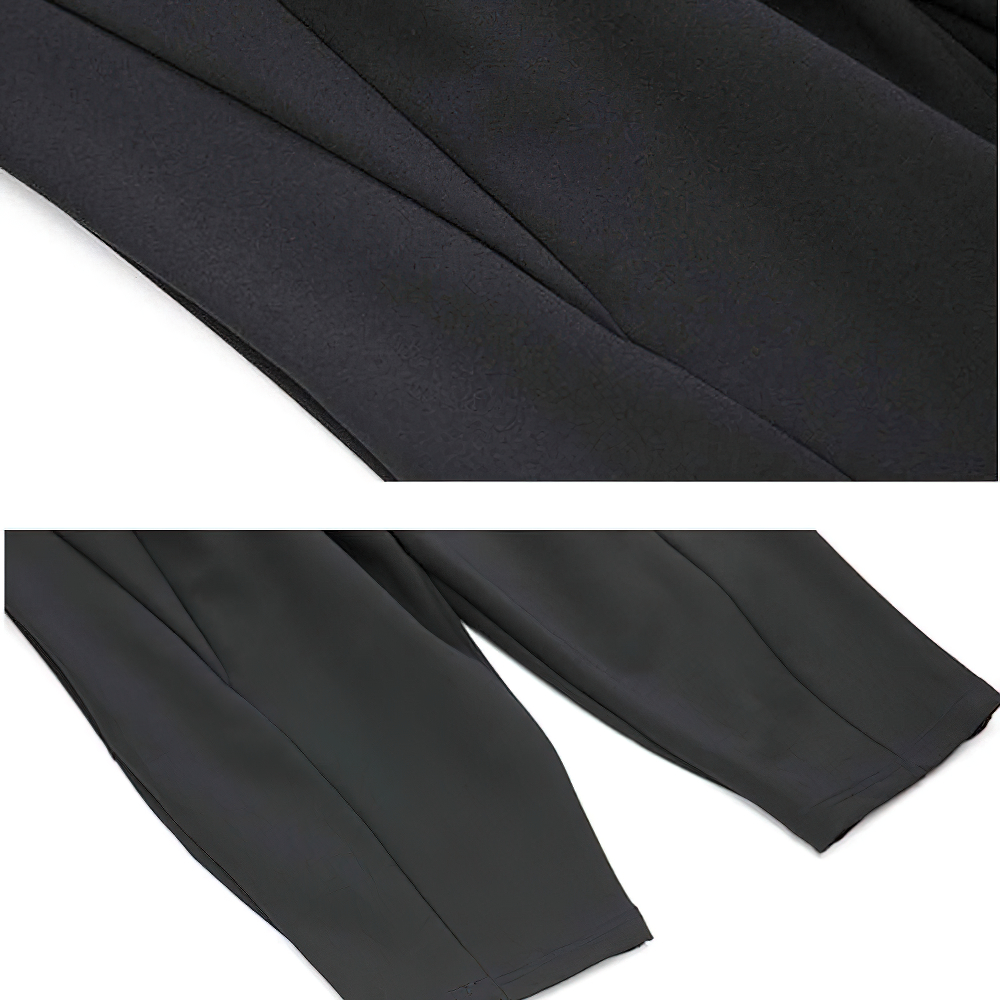 Close-up view of high waist black long harem trousers showing the fabric texture and loose-fit style.