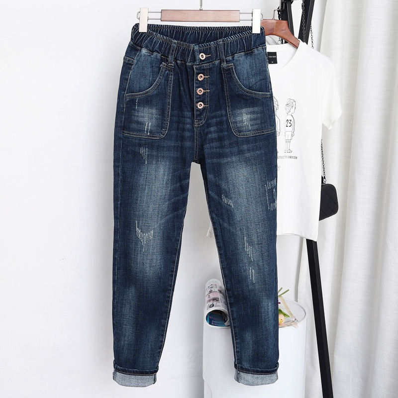 Stylish women's loose blue jeans with pockets, high waist, and button details for trendy streetwear looks.