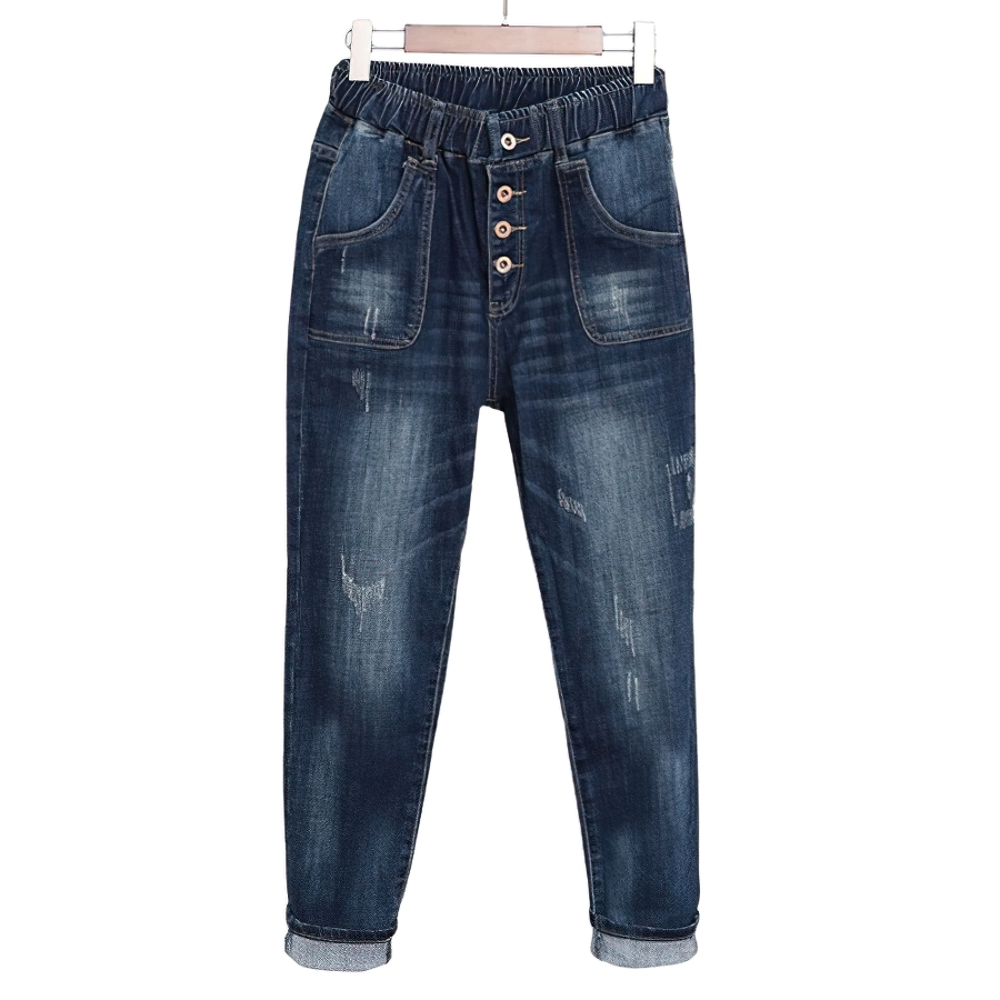 Fashionable women's loose jeans with high waist, pockets, and button detailing in blue denim.