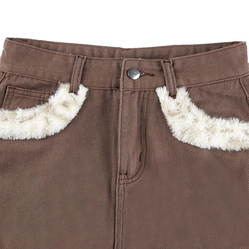 Close-up of women's high waist jeans skirt with furry leopard inserts, showcasing stylish casual fashion details.