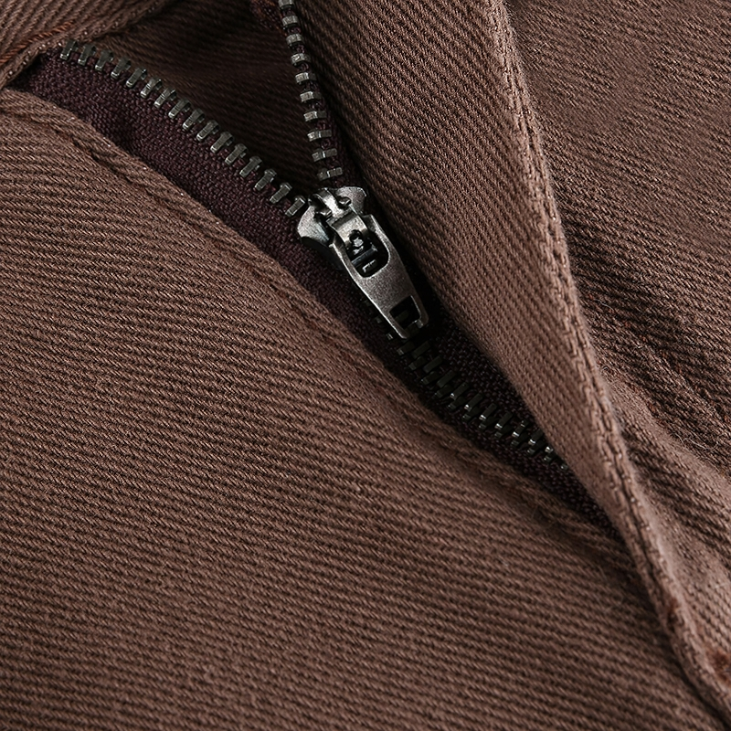 Close-up of a brown fabric with a zipper detail, showcasing the stylish design of casual wear.