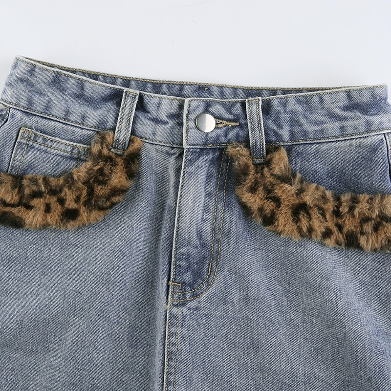 Close-up of women's high waist jeans skirt with leopard fur inserts, showcasing casual fashion style.