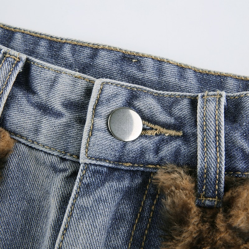 Close-up of women's high waist jeans skirt showcasing button detail and furry leopard inserts.