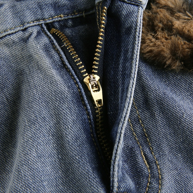 Close-up of a gold zipper on women's high waist jeans skirt, showcasing stylish denim and leopard fur detail.