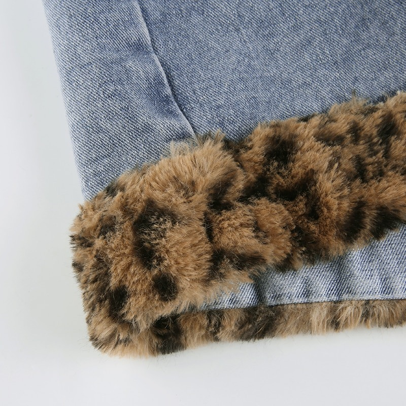 Close-up of women's leopard fur trim on denim high-waist jeans skirt, showcasing stylish casual fashion details.