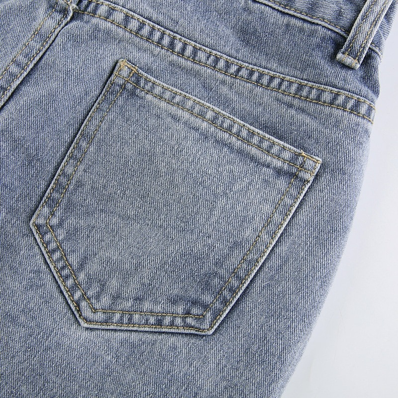 Close-up of the back pocket on women's high waist jeans skirt in light denim, showcasing stylish casual fashion.
