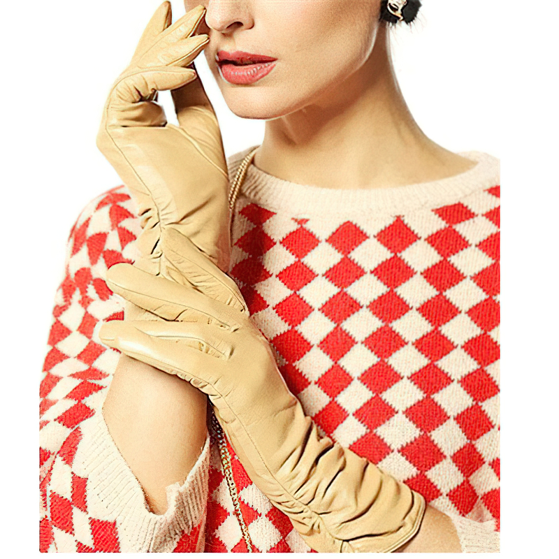 Woman wearing stylish beige leather gloves against a red and white patterned sweater, showcasing elegance and warmth.
