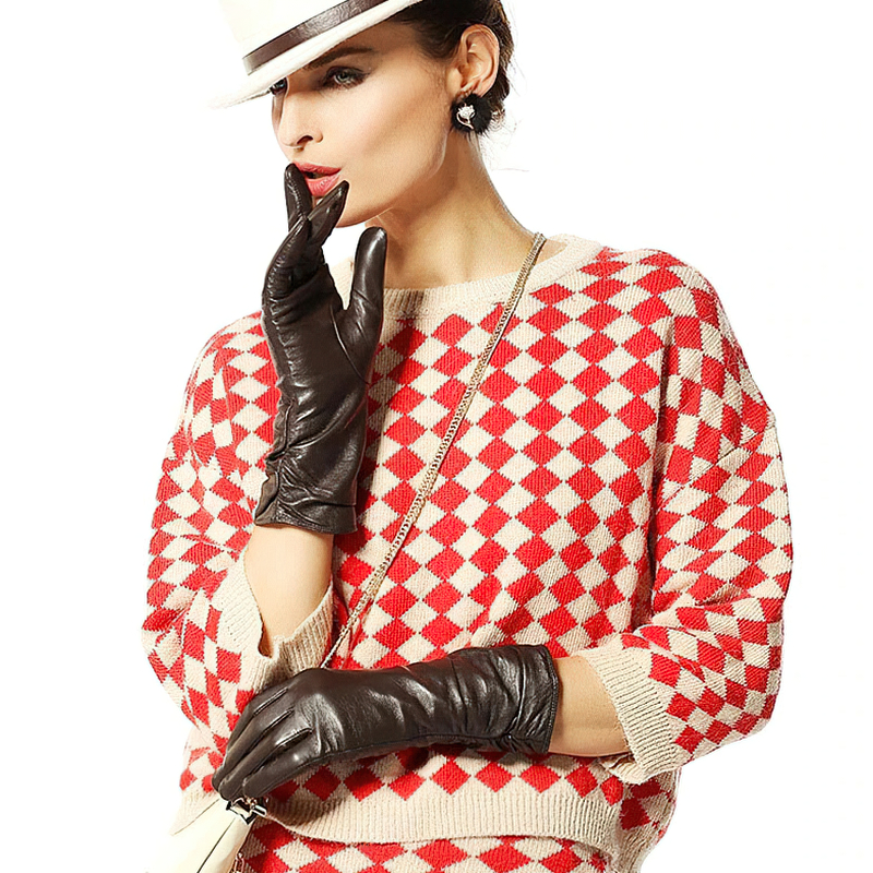 Fashionable woman in a checkered sweater wearing elegant brown leather gloves, showcasing warmth and style.