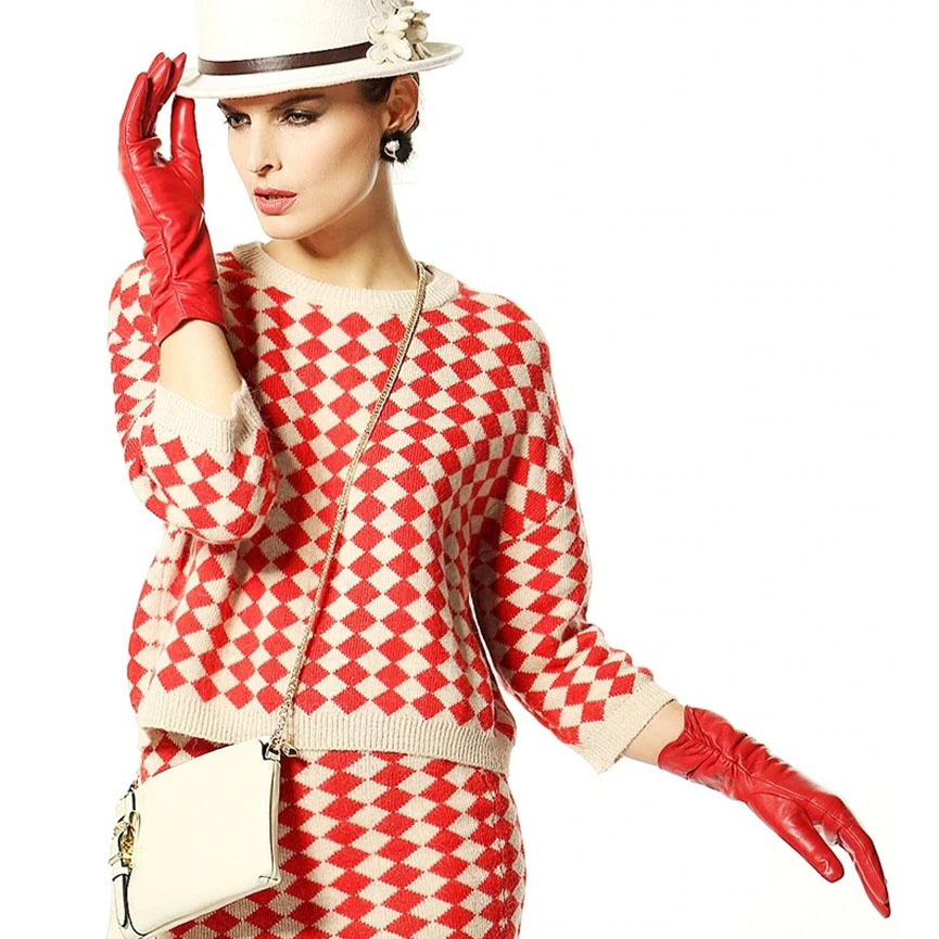 Woman in red leather gloves and patterned sweater, showcasing stylish winter fashion.