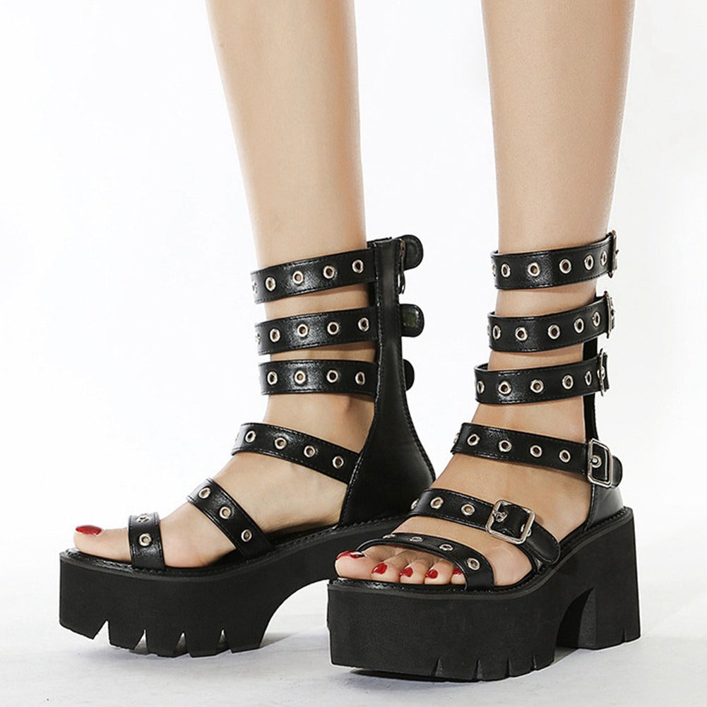 Elegant women's black gladiator platform sandals with zippers, buckles, and rivets for fashionable summer style.