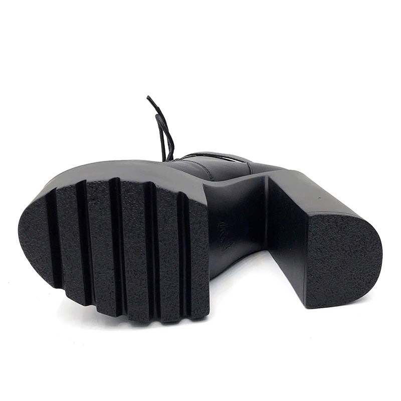 Black platform ankle boot sole with high square heel, perfect for alternative fashion styles.