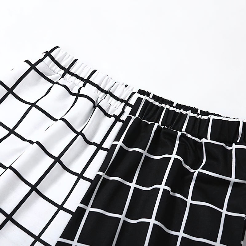 Close-up of women's gothic cargo pants featuring black and white checkerboard print fabric details.