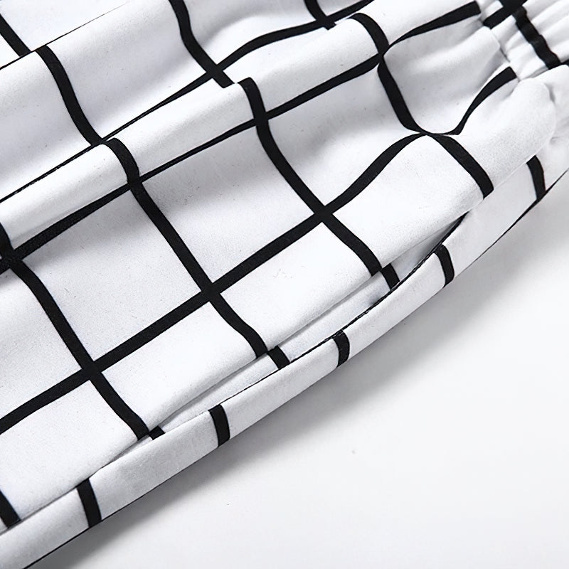 Close-up of black-white checkerboard print detailing on women's gothic cargo pants.