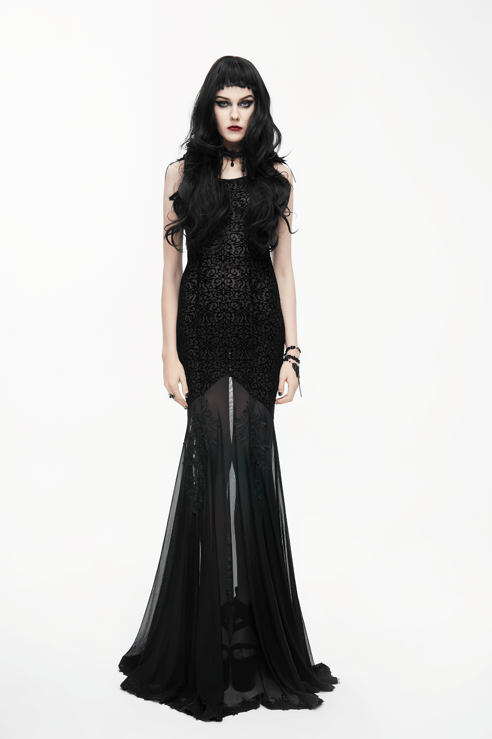 Elegant women's gothic long dress featuring a transparent bottom and intricate embroidery, styled by a model.
