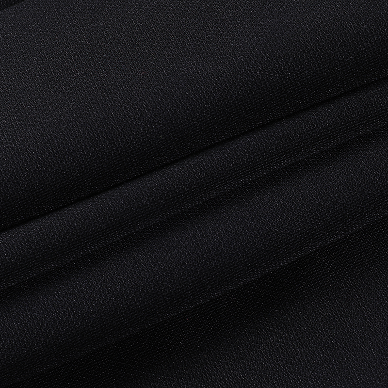Close-up of soft black fabric, showcasing texture suitable for gothic-inspired fashion items.