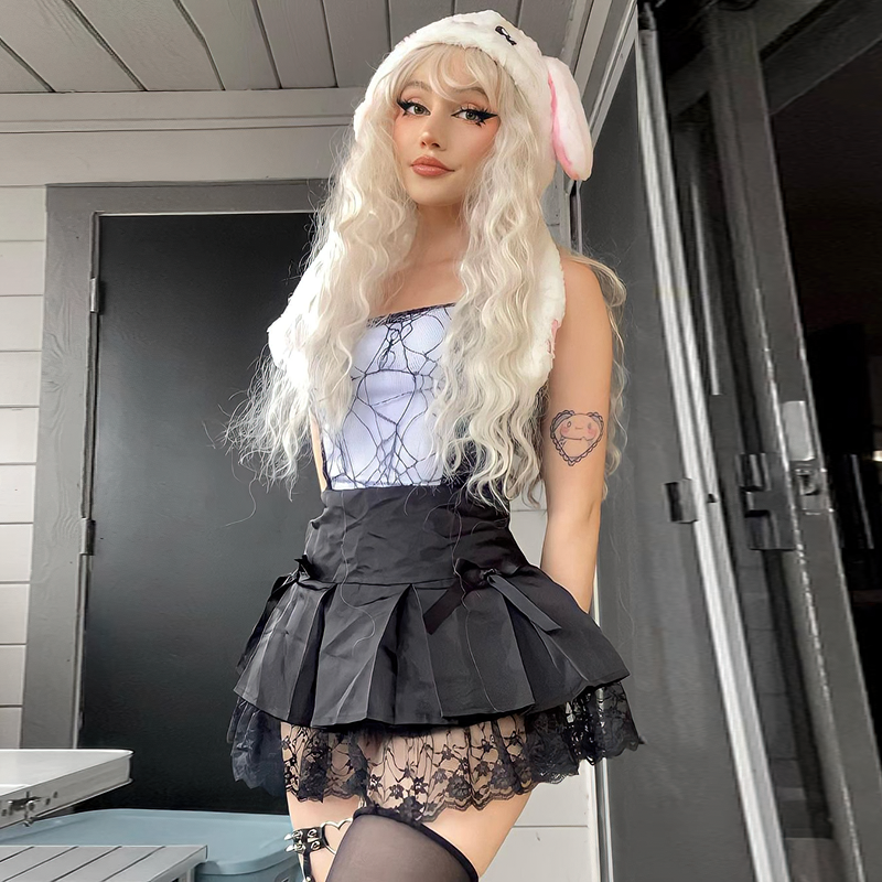 Model wearing a gothic black and red sleeveless patchwork crop top with lace, paired with a cute skirt and accessories.