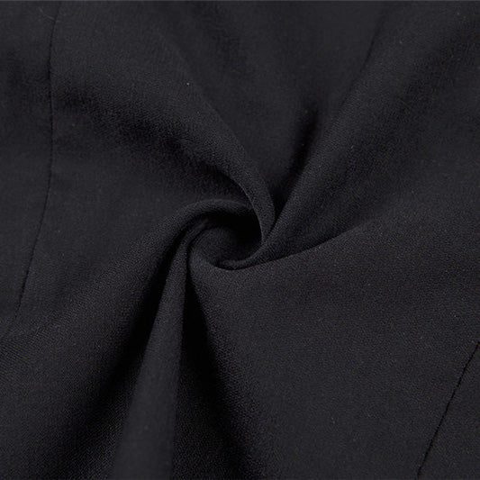Close-up of soft black cotton fabric used in women's gothic tops, showing texture and design details.