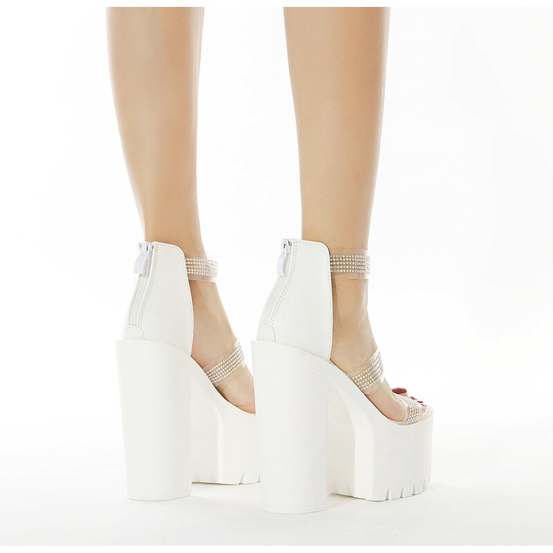Side view of women's heeled sandals with rhinestones, showcasing elegant white platforms and stylish design.