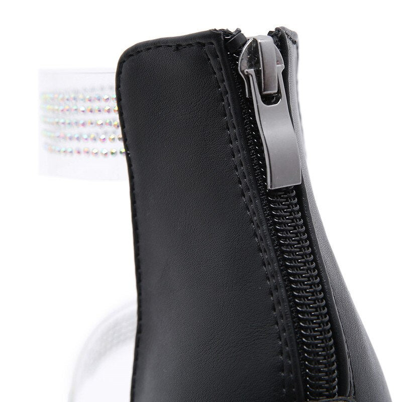 Close-up of women's heeled sandals featuring a zipper and rhinestone strap for elegant style.