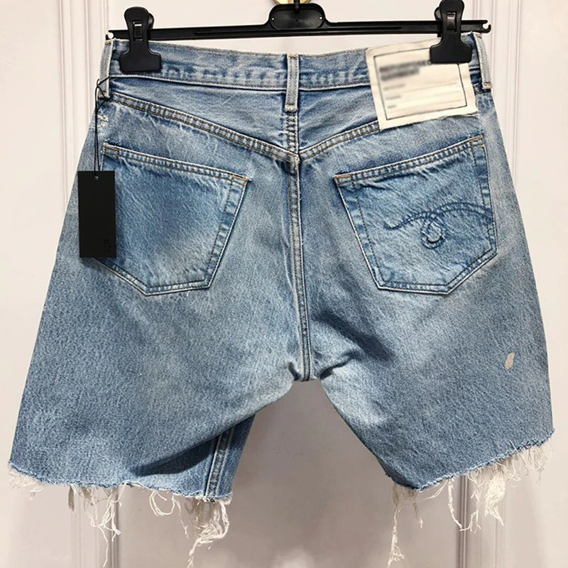 Back view of women's high waist denim shorts in light blue with pockets and frayed hem, perfect for summer outings.