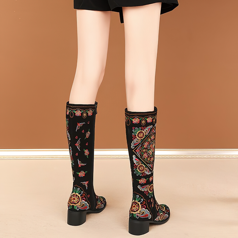 Women's knee-high embroidered boots showcasing vibrant ethnic patterns and thick heels, perfect for stylish comfort.