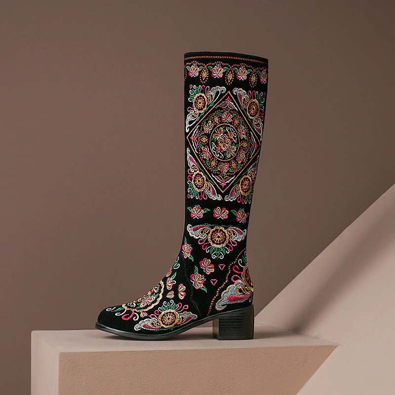 Stylish women's knee-high boots with vibrant embroidery and thick heels, perfect for any ethnic-inspired outfit.
