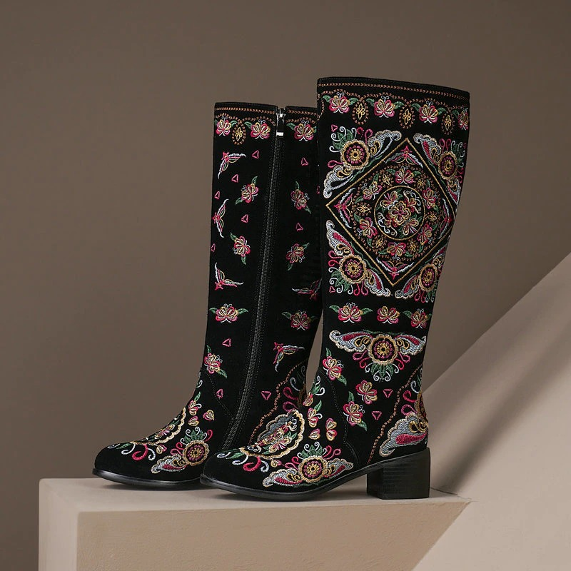 Women's knee high embroidered boots in ethnic style, made of suede with thick heels and zipper detail.